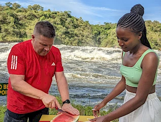 a couple enjoying a sun-downer during the top of the murchison falls hike